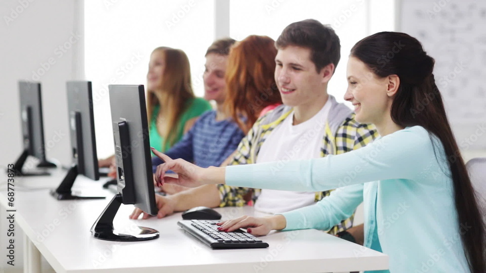 smiling students working with computers at school smiling students working with computers at school