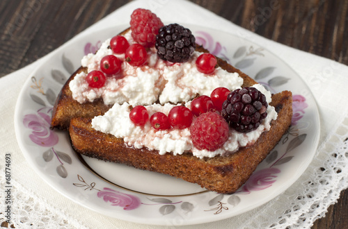Toast of black bread with curd cream and raspberry, blackberry a