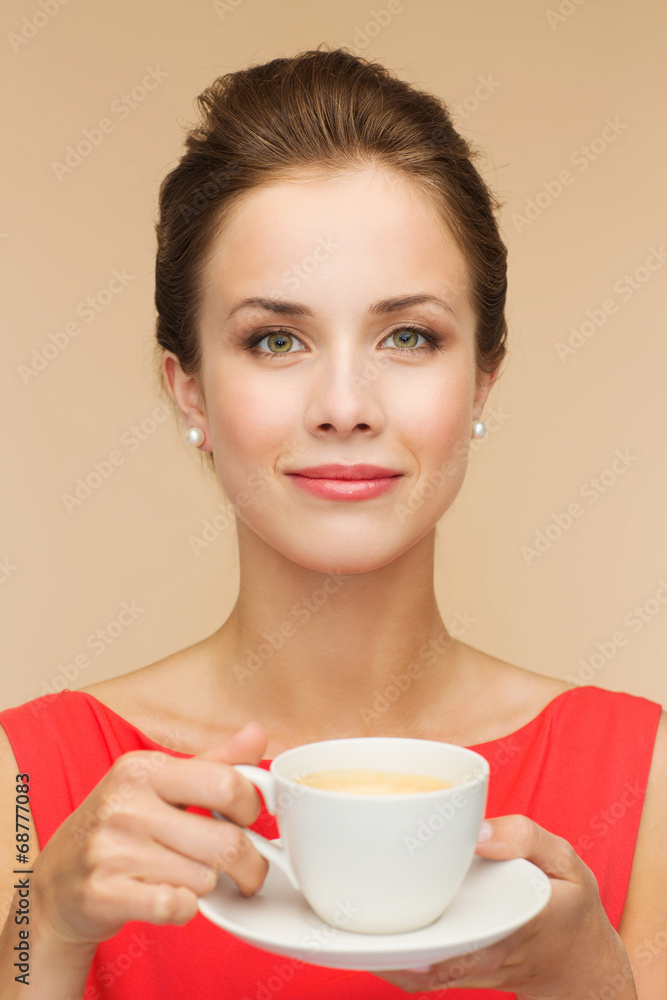 smiling woman in red dress with cup of coffee smiling woman in red dress with cup of coffee