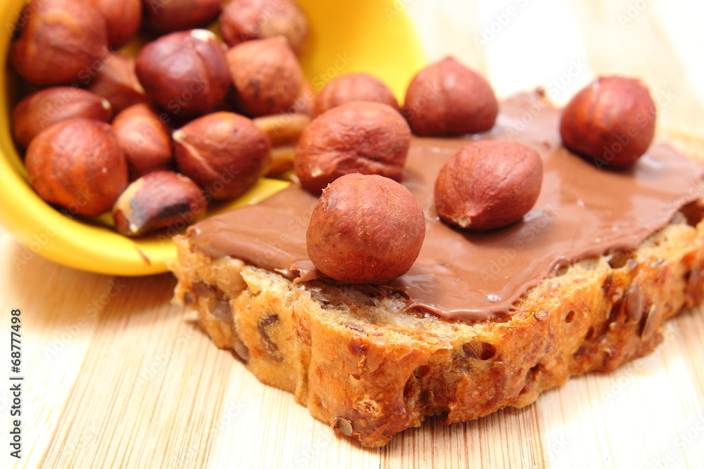 Hazelnut and slices of bread with chocolate cream Hazelnut and slices of bread with chocolate cream