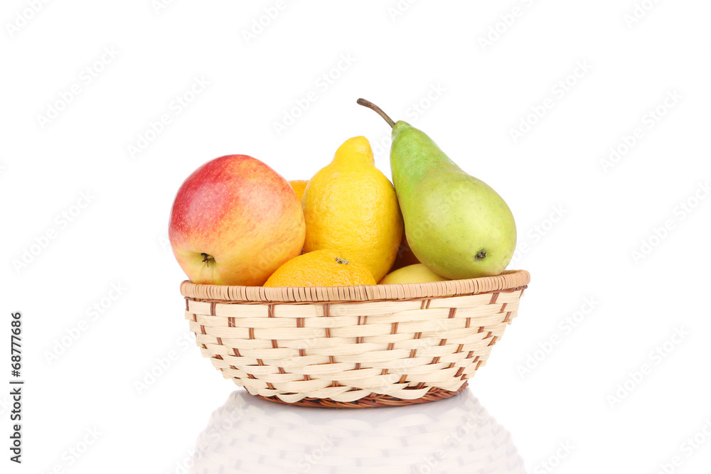 Wicker basket full of juicy fruits.