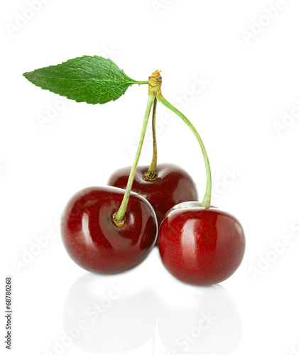 Juicy sweet cherry with leaf isolated on white background