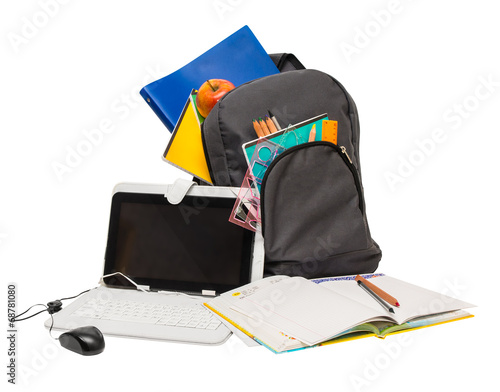 School backpack with school supplies and a tablet computer . © pyansetia2008