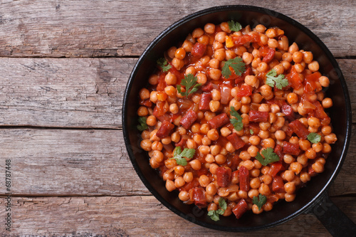 Chickpeas with chorizo ​​in a pan top view