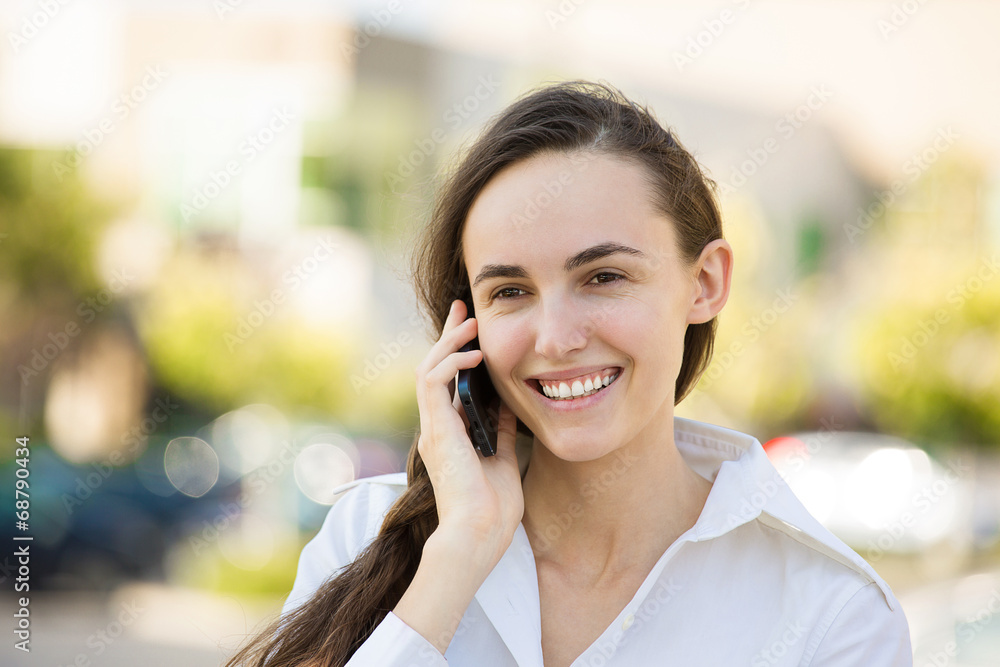 Portrait Happy young woman talking on mobile phone Portrait Happy young woman talking on mobile phone