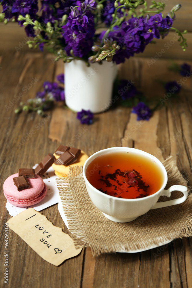 Cup of fresh herbal tea on wooden table Cup of fresh herbal tea on wooden table