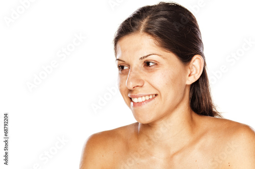 portrait of a young smiling woman without make up on a white