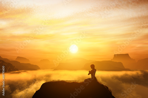Woman meditating in yoga position on the top of mountains
