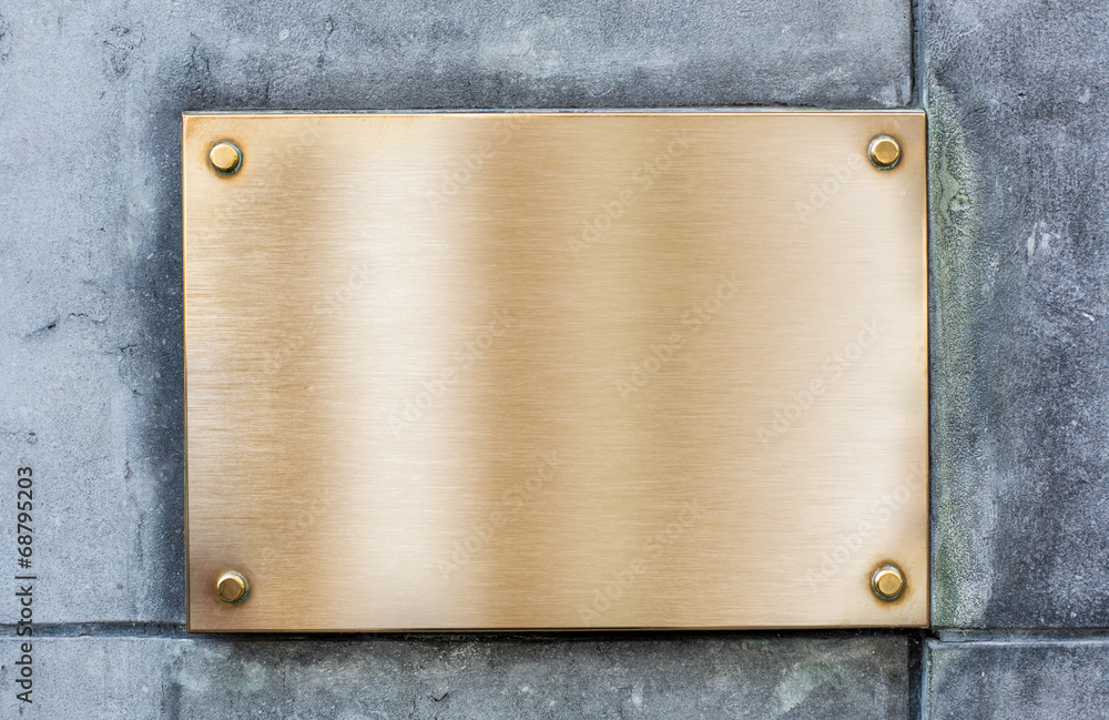 Obraz premium Golden plate or plaque made of bronze on vintage wall