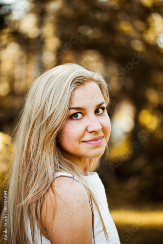 Autumn outdoor portrait of beautiful young blond woman