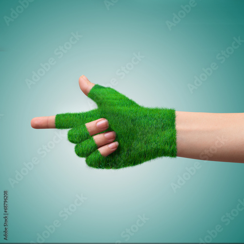 Go Green Concept.Hand in glove grass indicates the direction. photo