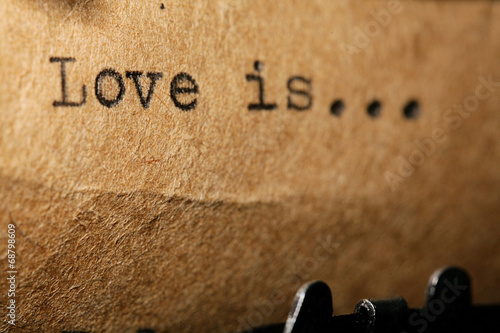 Fototapeta love is, the inscription on a typewriter