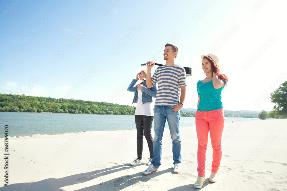Group of friends walking on the beach Group of friends walking on the beach