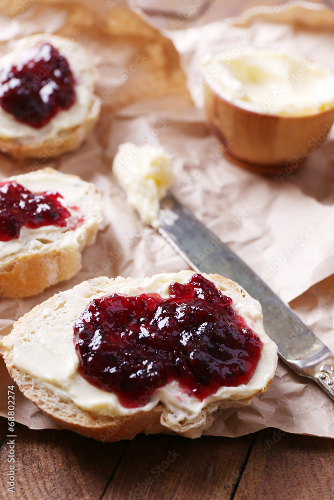 Fresh bread with homemade butter and blackcurrant jam