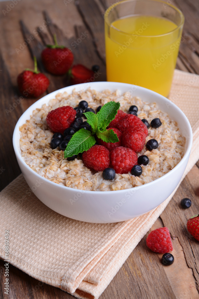 Tasty oatmeal with berries on table close-up Tasty oatmeal with berries on table close-up