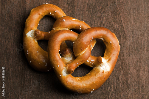 Two typical bavarian pretzel on a brown background