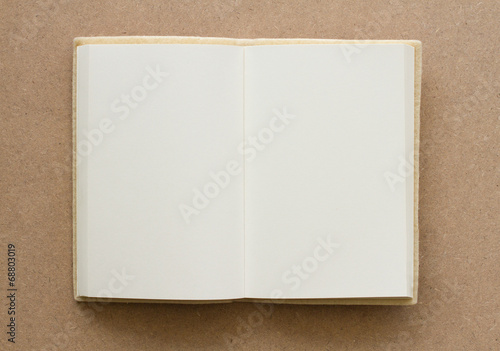 blank book open on a brown textured surface
