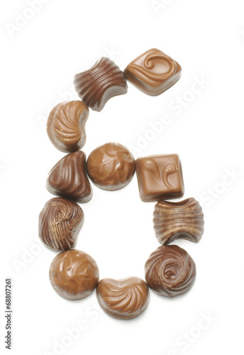 Number 6 arranged from chocolate sweets isolated