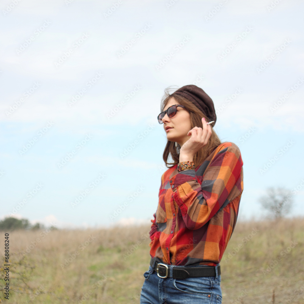 portrait of a beautiful hipster girl smoking outdoors portrait of a beautiful hipster girl smoking outdoors