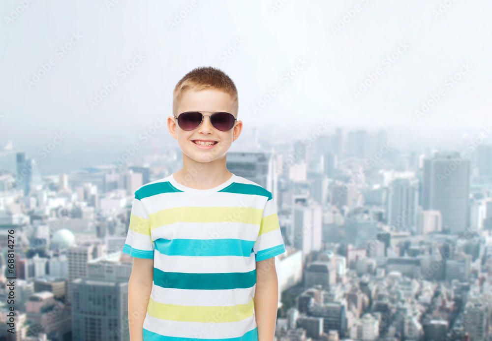 smiling little boy over green background