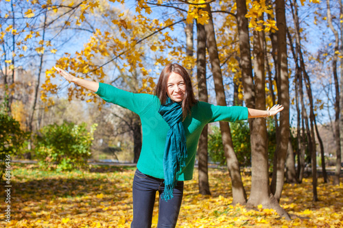 Happy young woman enjoy her autumn vacation in park © travnikovstudio