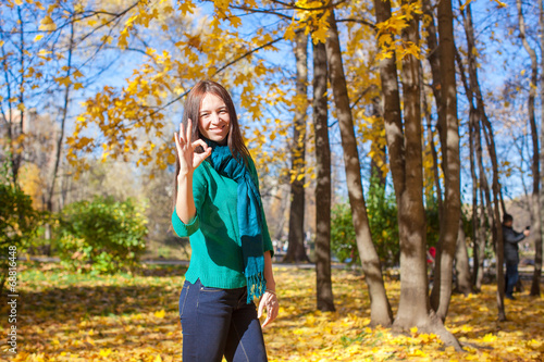 Young woman in autumn yellow park