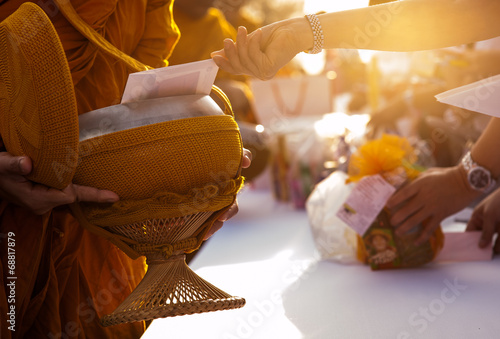 Fotografija Monk receiving food and items offering from people