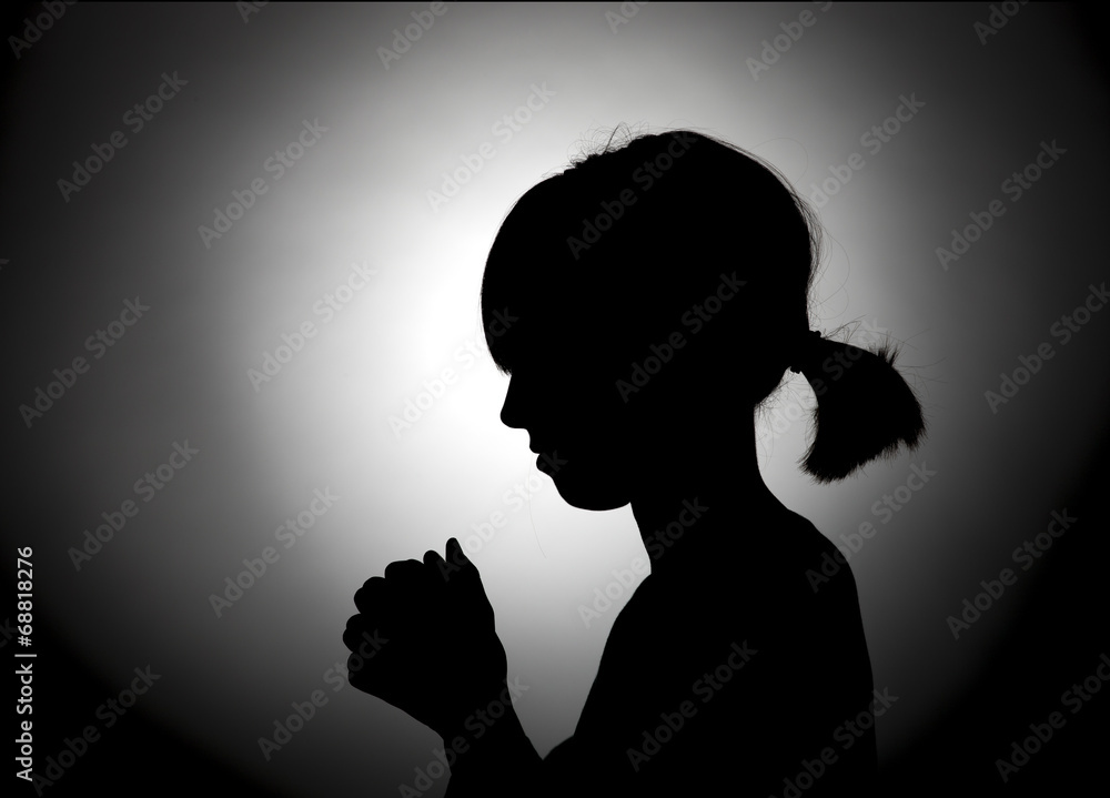 Girl bowed in prayer.