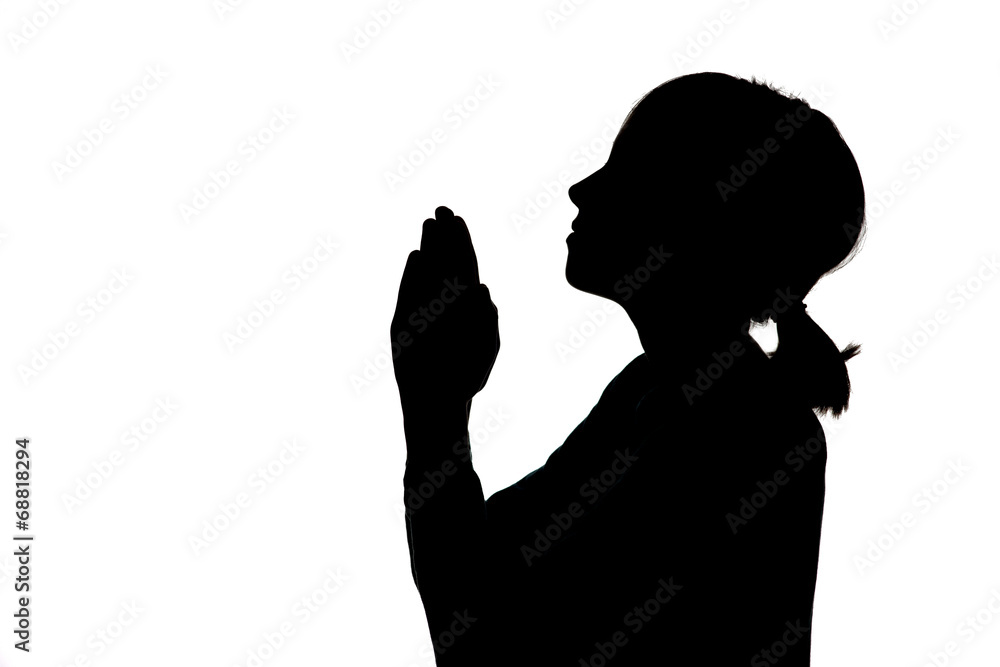 Silhouette of girl praying.