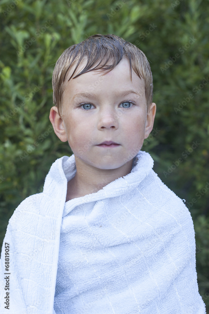 Little boy wrapped in a towel after swimming. Little boy wrapped in a towel after swimming.