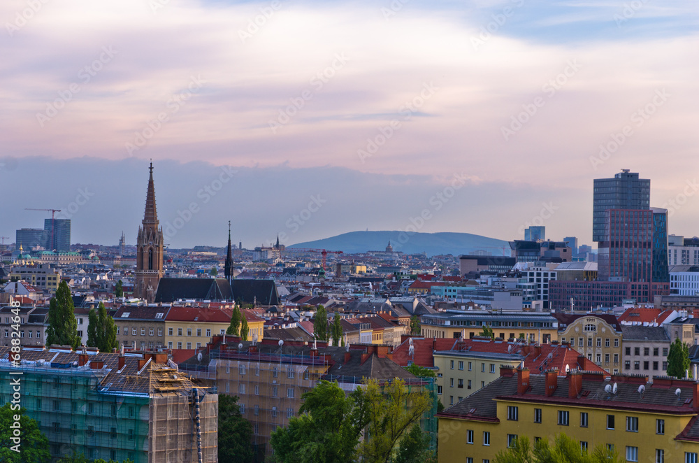 Naklejka premium Vienna cityscape at sunset, different ages, styles and colors
