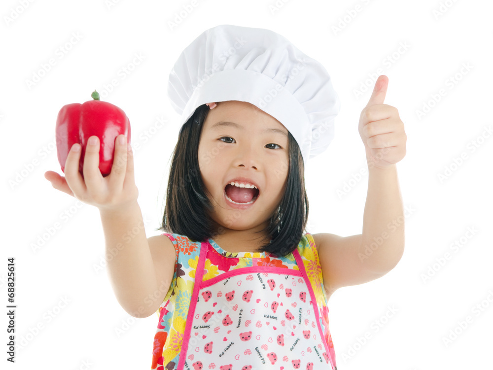 Asian girl holding a capsicum and thumbs up Asian girl holding a capsicum and thumbs up
