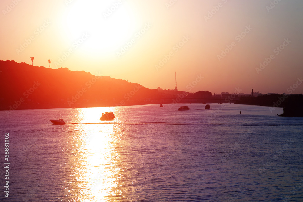 Evening landscape with river and boats
