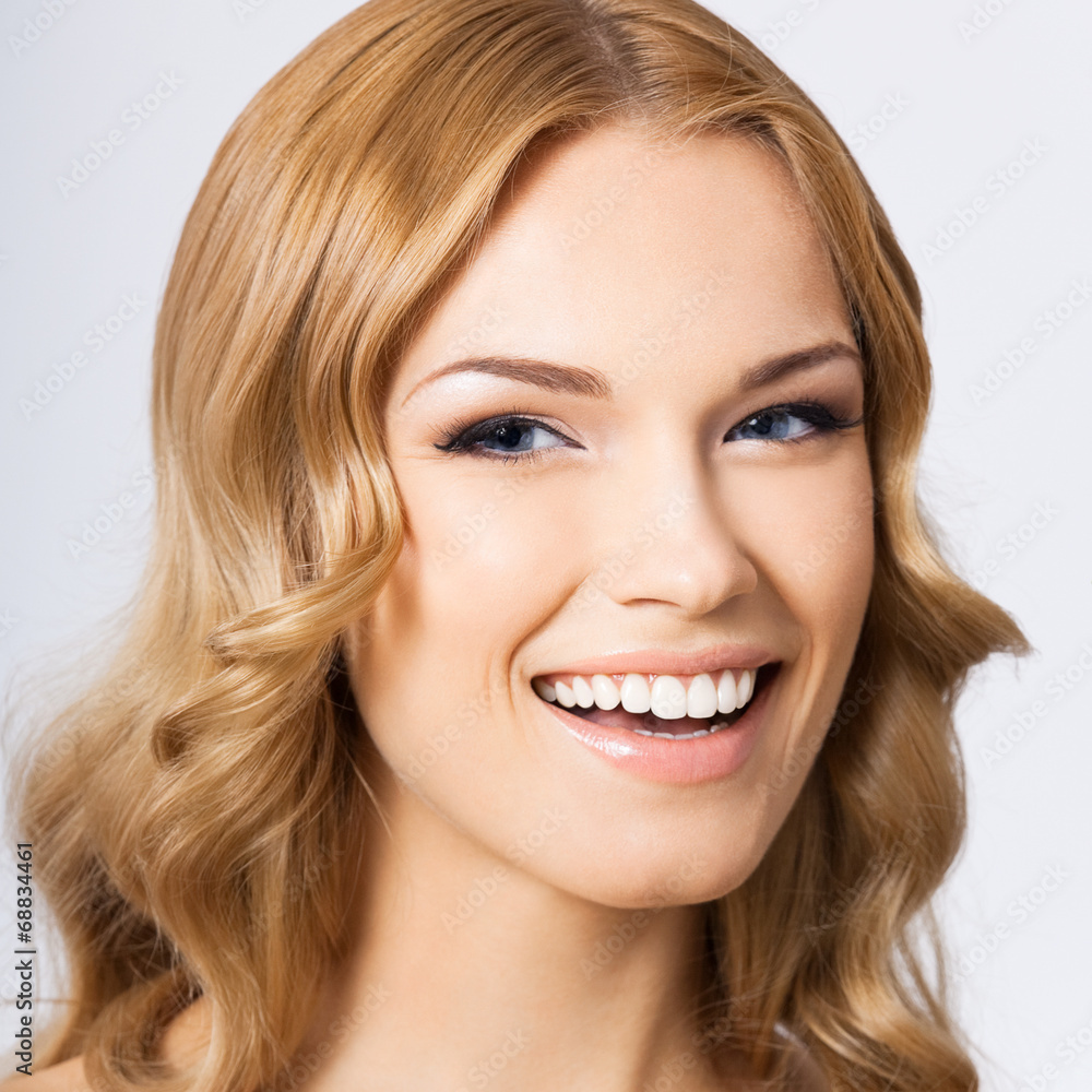 Young cheerful smiling woman, on gray Young cheerful smiling woman, on gray