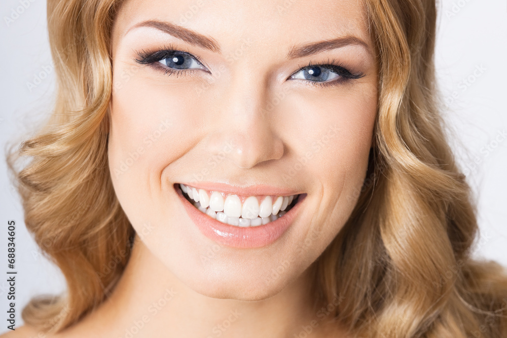 Young cheerful smiling woman, on gray Young cheerful smiling woman, on gray