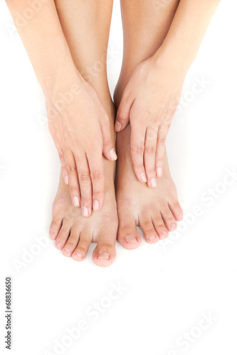 Beautiful woman's legs and hands on feet. © BlueSkyImages
