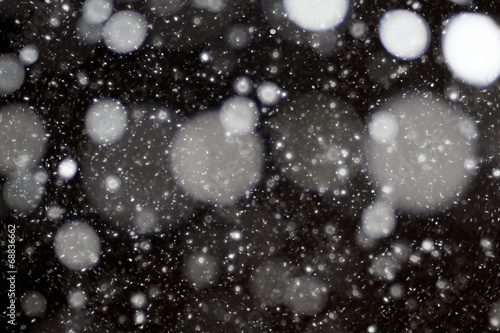 snow bokeh texture on black background © kichigin19