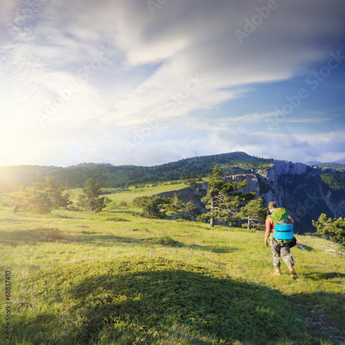 Woman traveller on mountain field