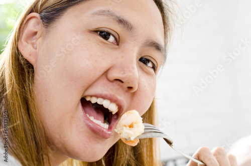 Healthy lifestyle woman eating shrimp smiling happy on beautifu