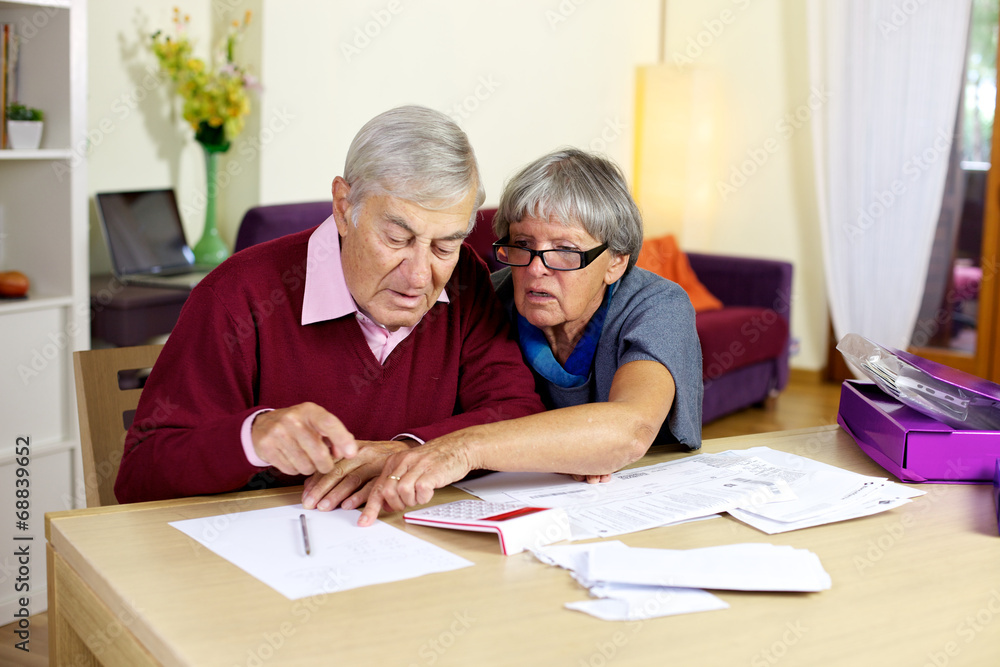 Senior couple in trouble calculating bills and taxes Senior couple in trouble calculating bills and taxes