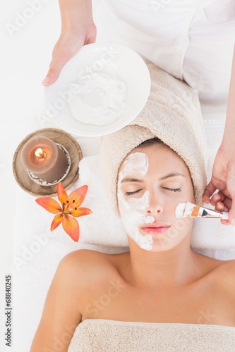 Attractive young woman receiving treatment at spa center