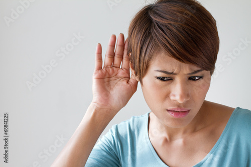 woman suffers from hearing impairment, hard of hearing, hearing photo