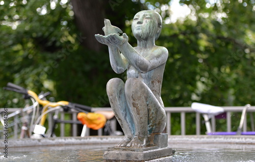 fontaine...statue d une femme assise tenant un pigeon 