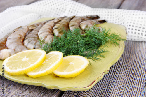 Square plate of prawns with dill and lemon