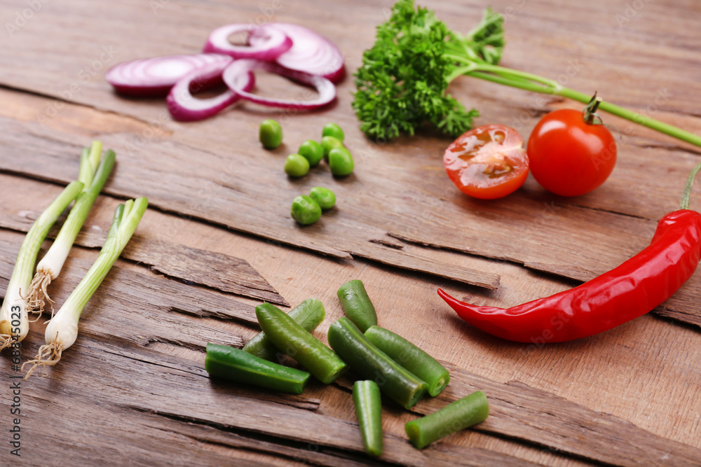 Different kind of raw vegetables on wooden table Different kind of raw vegetables on wooden table
