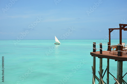Wooden Jetty on Seaview background with Dhow boat