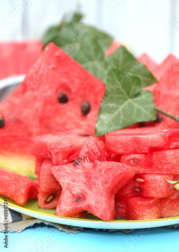 Fresh slices of watermelon on table, on wooden background