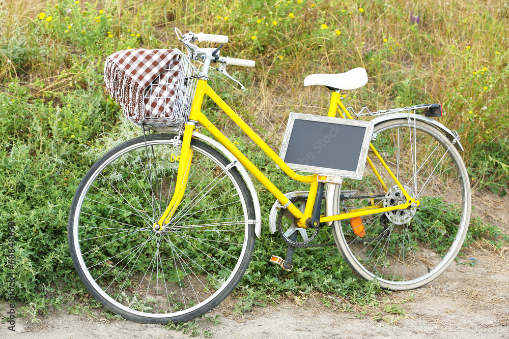 Bicycle with chalkboard in meadow during sunset Bicycle with chalkboard in meadow during sunset