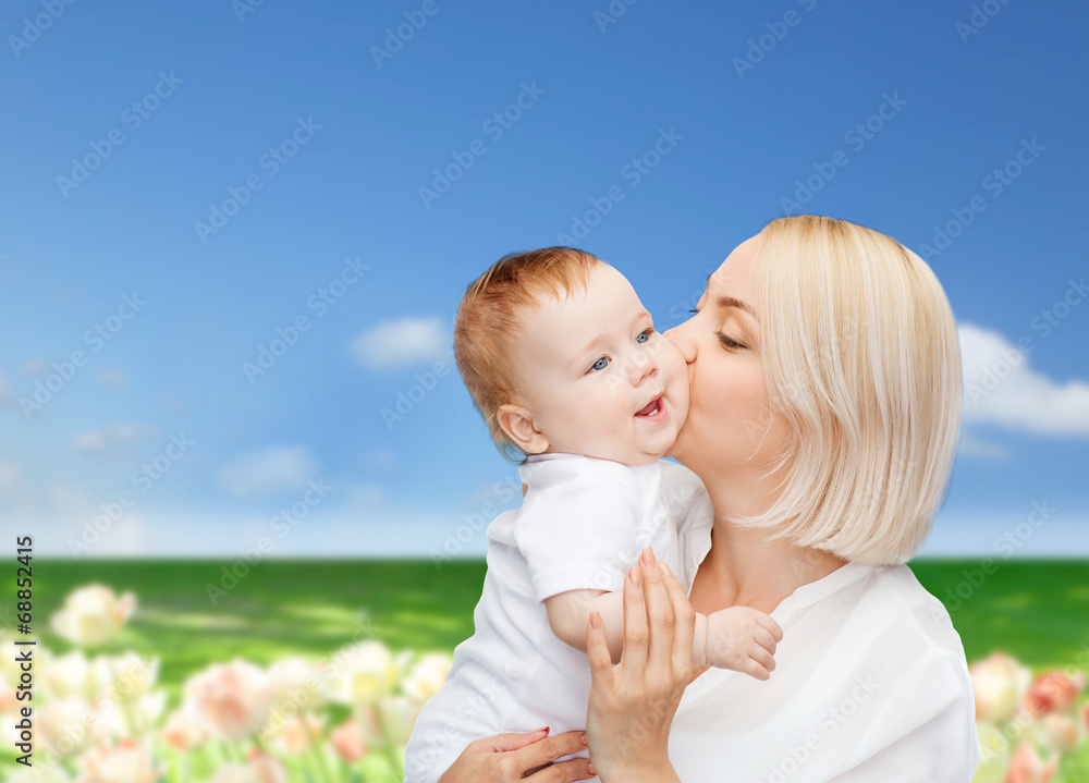 happy mother kissing smiling baby happy mother kissing smiling baby