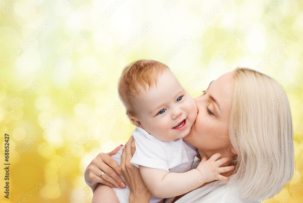 happy mother kissing smiling baby happy mother kissing smiling baby